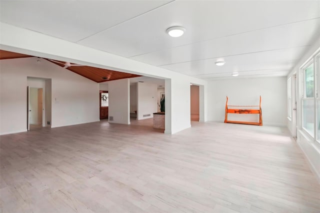 interior space featuring light wood-type flooring and vaulted ceiling