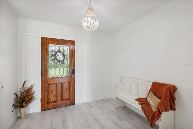 entrance foyer featuring a notable chandelier and light wood-type flooring