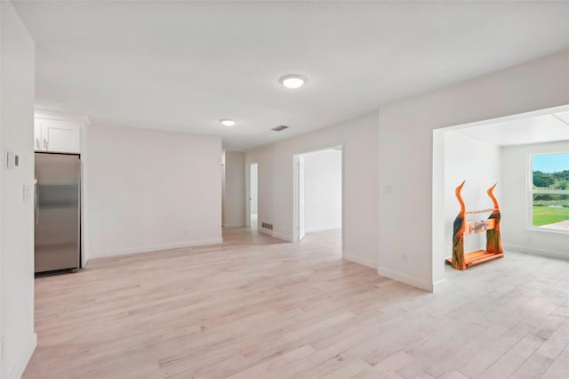 spare room featuring light wood-type flooring