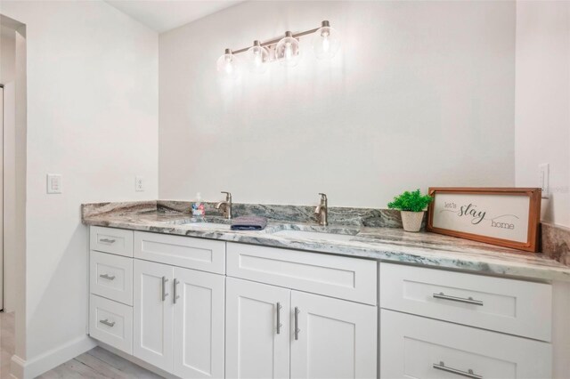 bathroom featuring vanity and hardwood / wood-style flooring