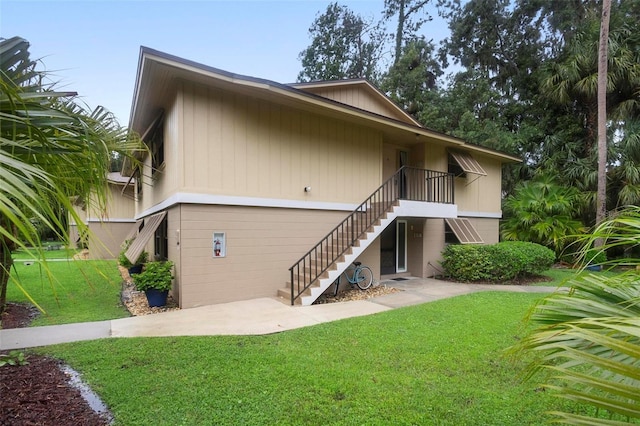 back of property with a yard and a patio