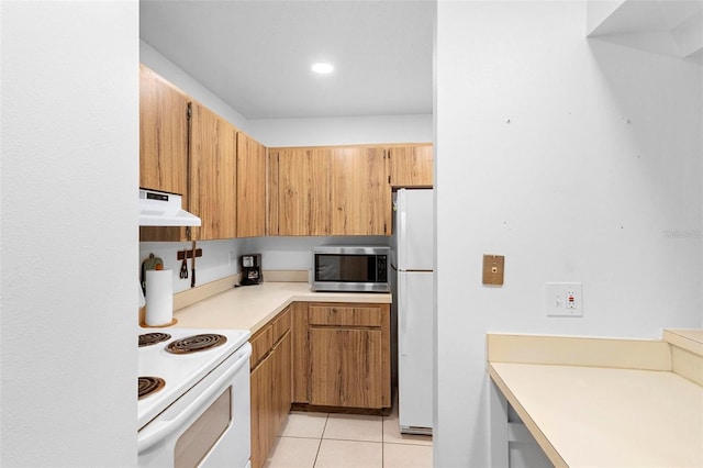 kitchen with light tile patterned floors and white appliances