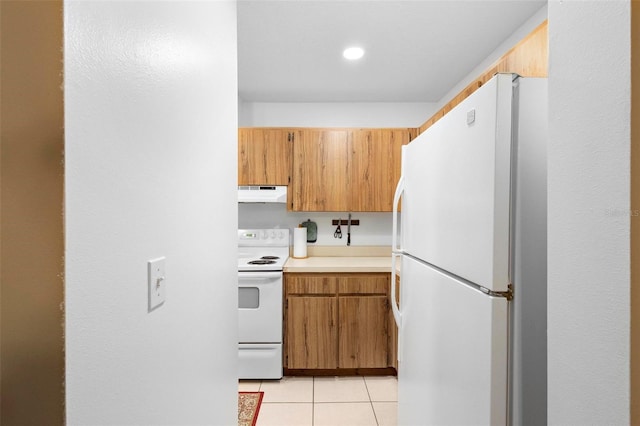 kitchen with light tile patterned flooring and white appliances