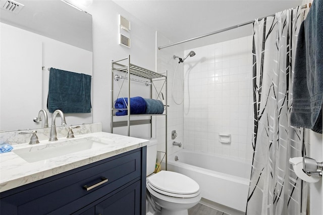 full bathroom with vanity, toilet, and shower / tub combo