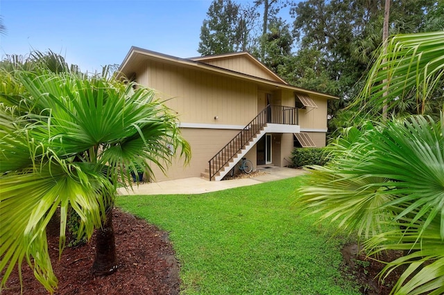 back of property featuring a yard and a patio