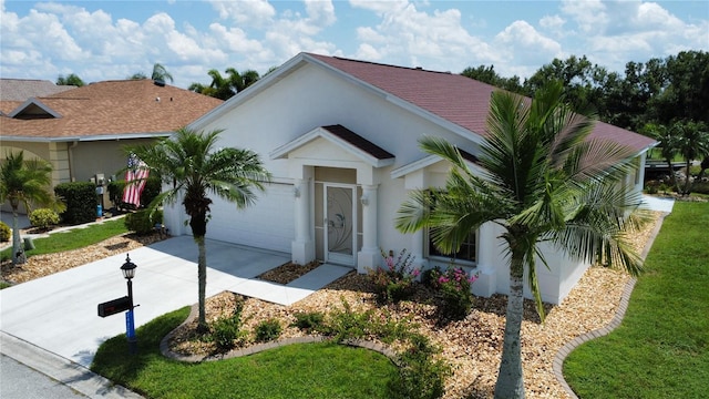 ranch-style house with a garage and a front yard