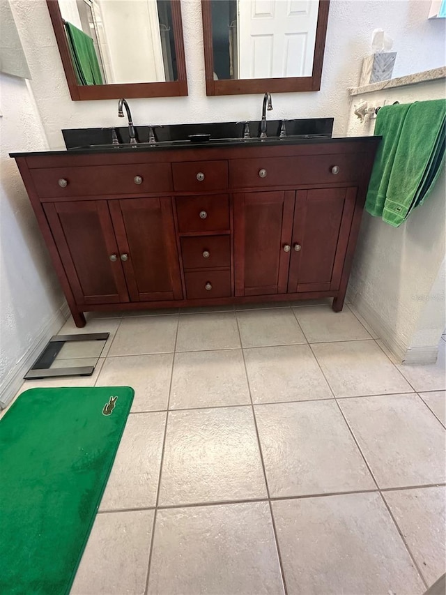 bathroom with tile patterned flooring and vanity