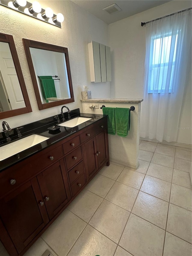 bathroom with tile patterned floors and vanity