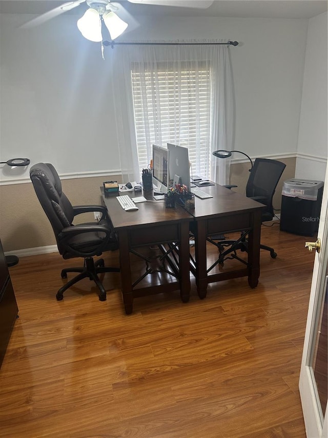 office with hardwood / wood-style flooring and ceiling fan