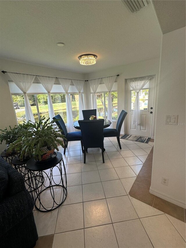 24327 Buckingham Way, Punta Gorda, FL 33980 - dining area with light tile patterned floors and baseboards