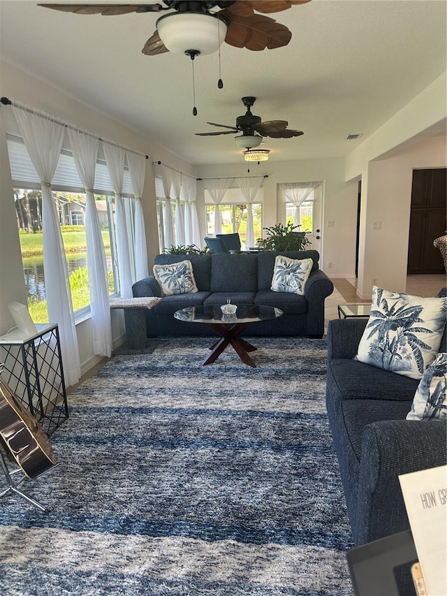 24327 Buckingham Way, Punta Gorda, FL 33980 - living room featuring ceiling fan, plenty of natural light, and carpet