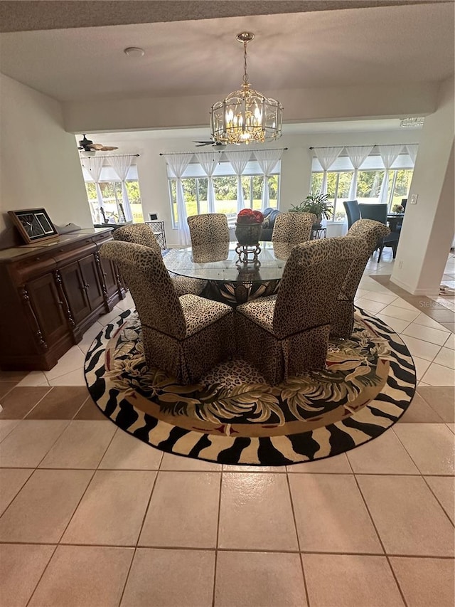 tiled dining area featuring ceiling fan with notable chandelier and plenty of natural light