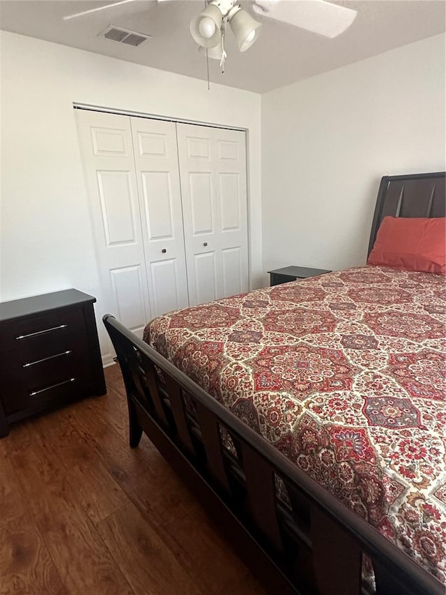 bedroom featuring a closet, ceiling fan, and dark wood-type flooring