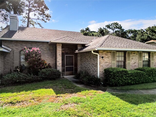 ranch-style house with a front lawn