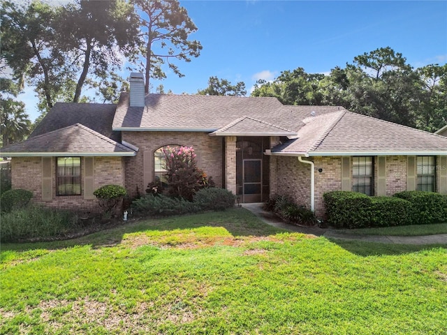 ranch-style home with a front lawn