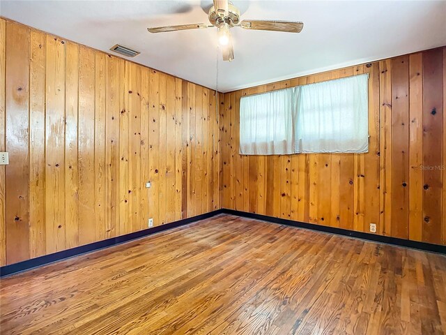 spare room featuring wood-type flooring and ceiling fan