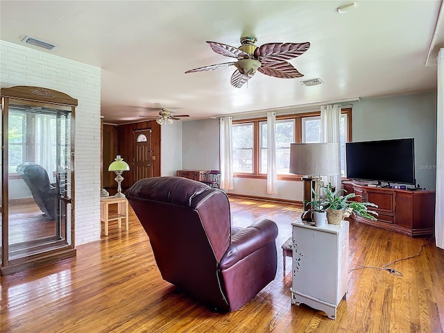 living room featuring hardwood / wood-style flooring and ceiling fan