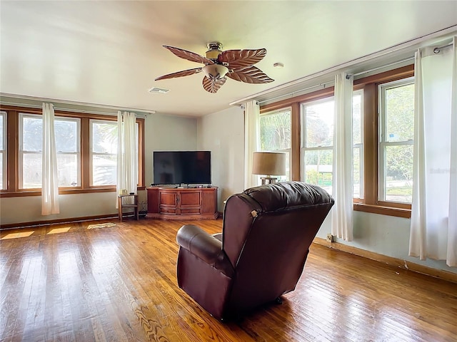 living room with hardwood / wood-style floors and ceiling fan