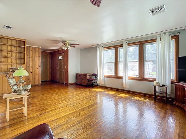 unfurnished living room with ceiling fan and light hardwood / wood-style flooring