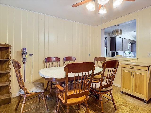 dining room with ceiling fan and light parquet flooring