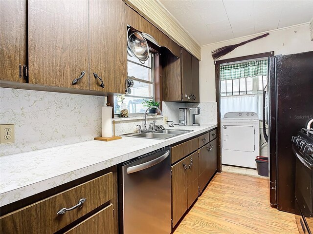 kitchen featuring sink, light hardwood / wood-style flooring, dishwasher, backsplash, and washer / dryer