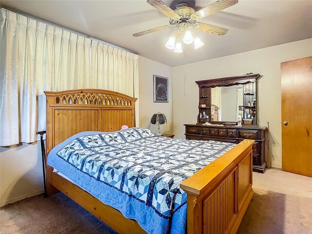 bedroom featuring light colored carpet and ceiling fan