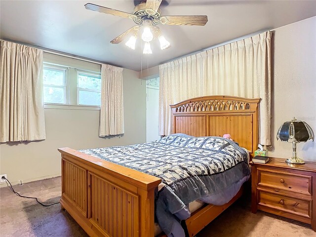 bedroom featuring ceiling fan and light carpet