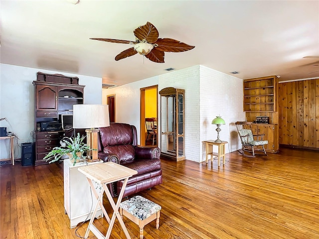 living room with hardwood / wood-style floors and ceiling fan