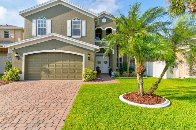 view of front of home featuring a garage and a front lawn