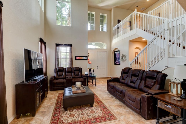 tiled living room featuring a high ceiling