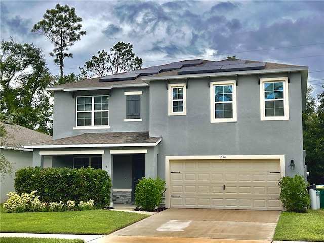 view of front of property featuring a garage, a front lawn, and solar panels