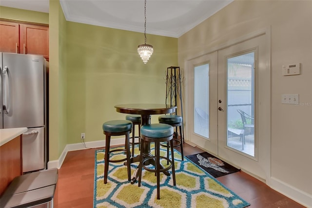 dining room featuring a notable chandelier, ornamental molding, french doors, and hardwood / wood-style floors