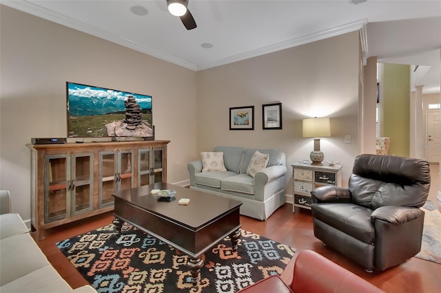 living room with ceiling fan, crown molding, and dark wood-type flooring