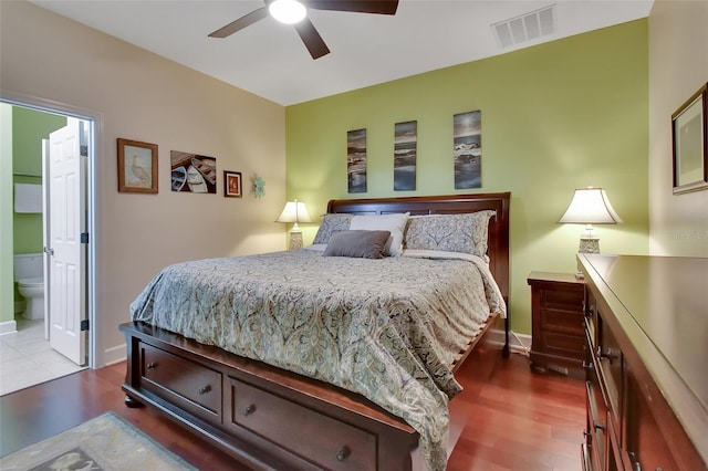 bedroom featuring hardwood / wood-style flooring, ensuite bathroom, and ceiling fan