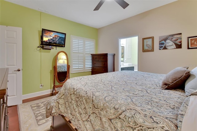 bedroom with wood-type flooring, ensuite bath, and ceiling fan