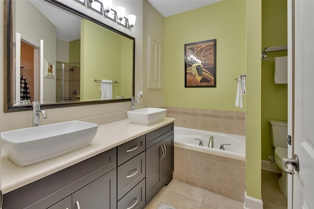 bathroom with toilet, tile patterned floors, and dual bowl vanity