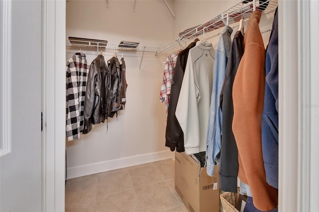 spacious closet featuring light tile patterned floors