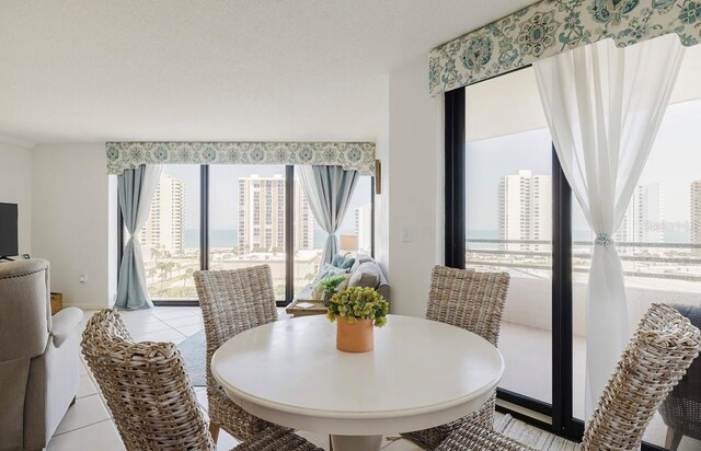 dining area with a textured ceiling and light tile patterned floors