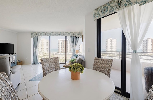 dining area with a textured ceiling and light tile patterned floors