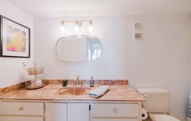 bathroom featuring toilet and vanity