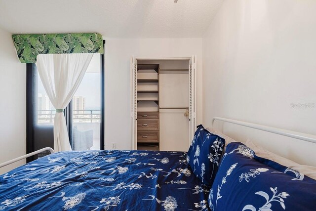 bedroom with a textured ceiling and a closet