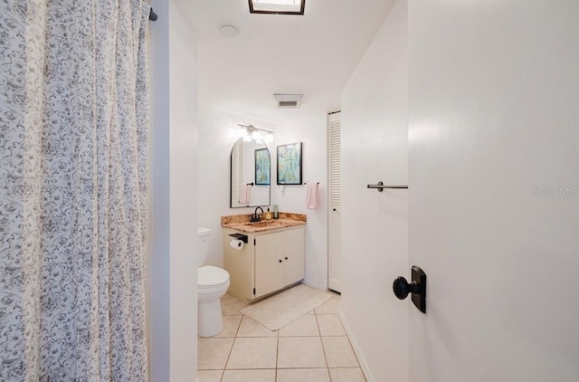 bathroom featuring toilet, tile patterned floors, and vanity