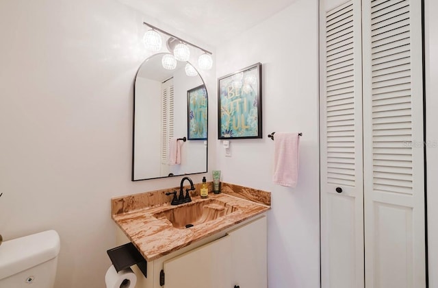 bathroom featuring toilet and vanity