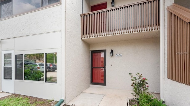 doorway to property featuring a balcony