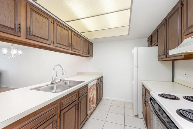 kitchen with an inviting chandelier, light tile patterned flooring, dishwasher, sink, and custom range hood