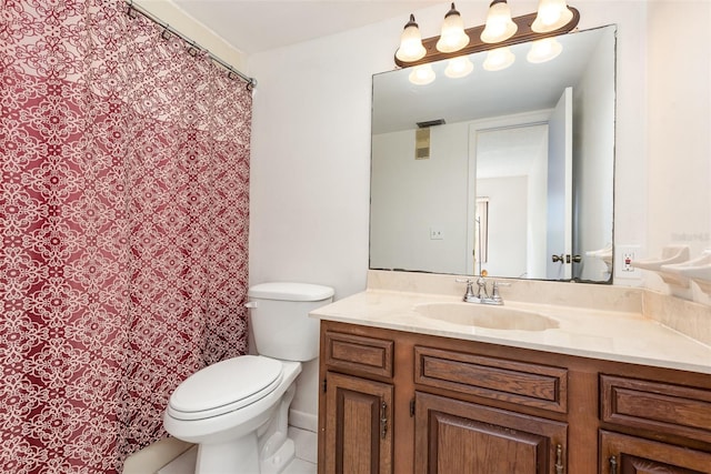 bathroom featuring toilet, tile patterned floors, and vanity