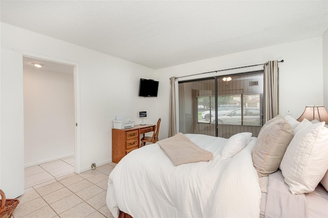 tiled bedroom with a textured ceiling