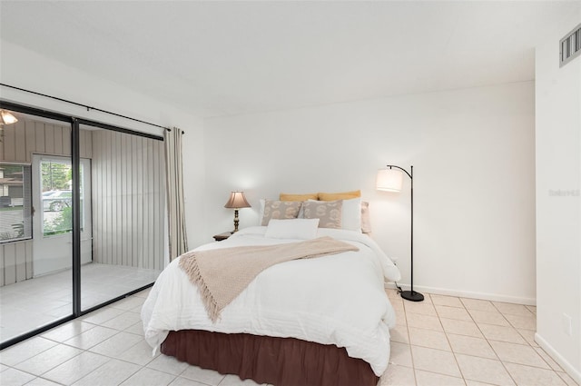 bedroom featuring access to exterior and light tile patterned floors
