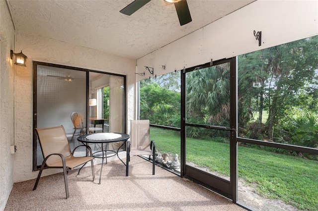 sunroom / solarium featuring lofted ceiling and ceiling fan