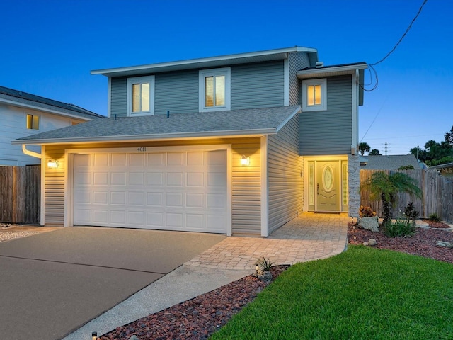 traditional home with roof with shingles, fence, driveway, and an attached garage